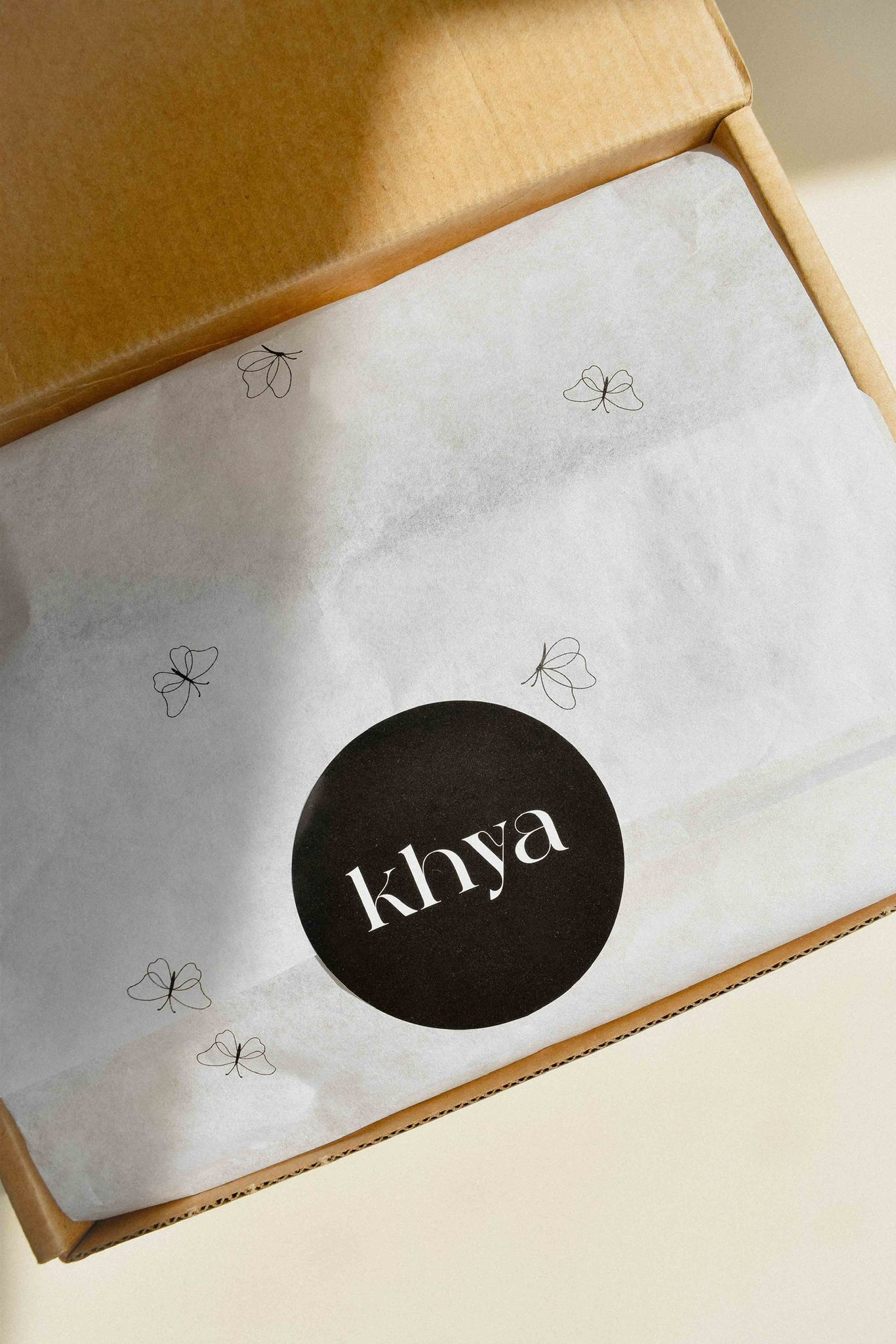 Open box with a branded wrapper inside featuring the 'khya' logo.