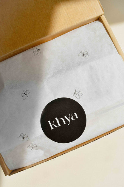Open box with a branded wrapper inside featuring the 'khya' logo.