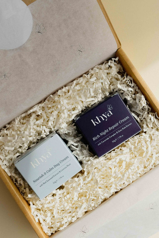 Two skincare cream boxes labeled 'Khya' in a box with shredded paper.